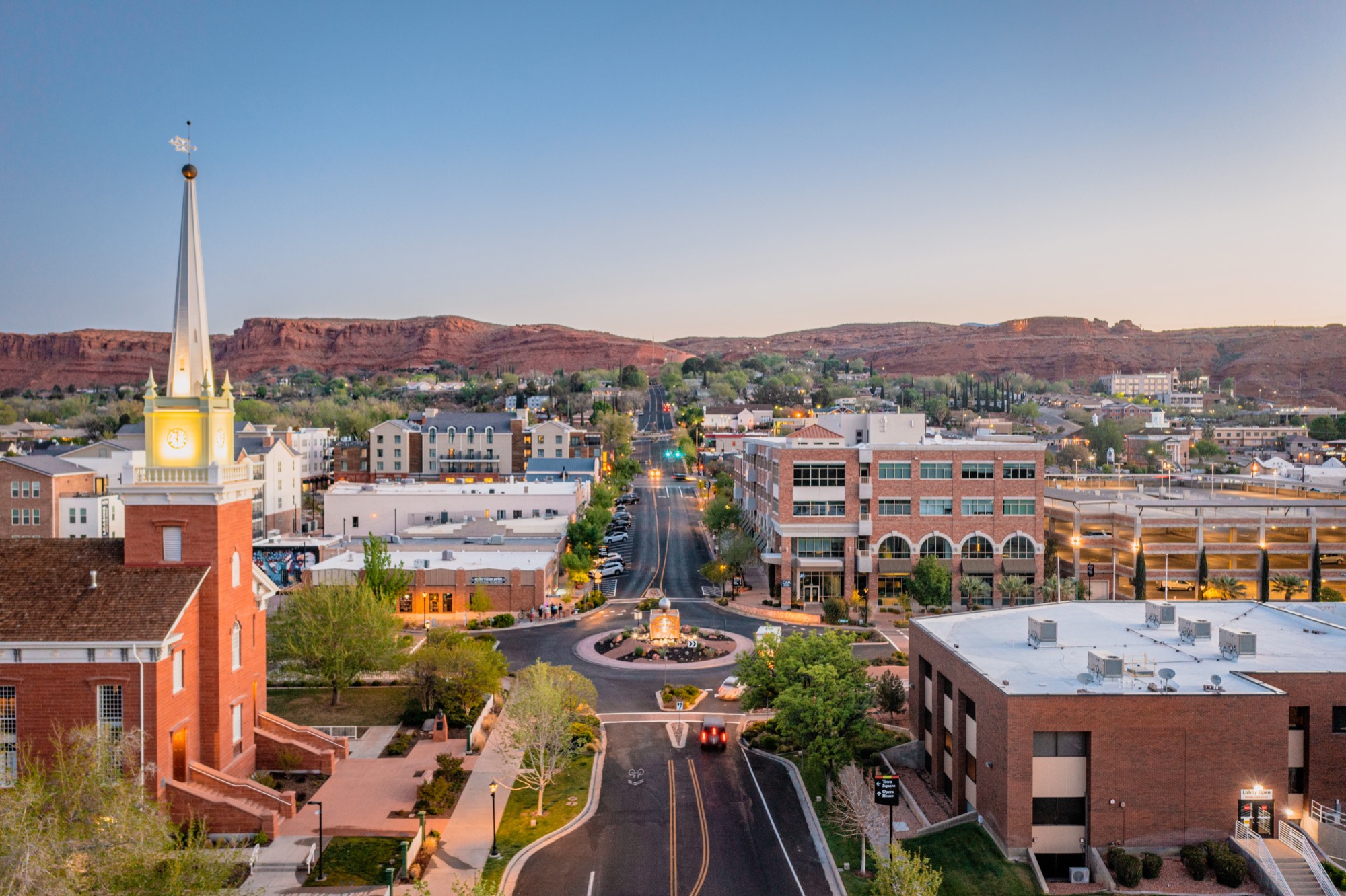 Downtown St. George at dusk, red rock ridge behind it